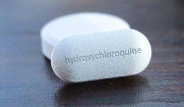 A Close-up Look Of White Hydroxychloroquine Tablets Placed On The Table.