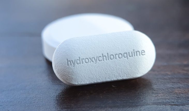 A Close-up Look Of White Hydroxychloroquine Tablets Placed On The Table.